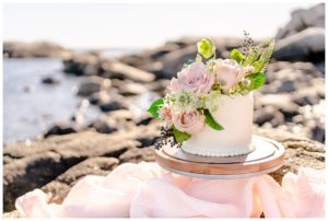 White cake with flowers on Maine coast for Maine lighthouse Elopement 