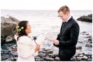 Couples exchanging vows during their Maine Lighthouse Elopement.